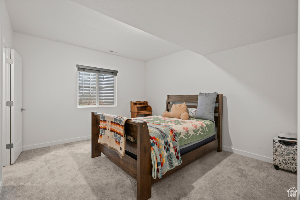 Carpeted bedroom featuring baseboards