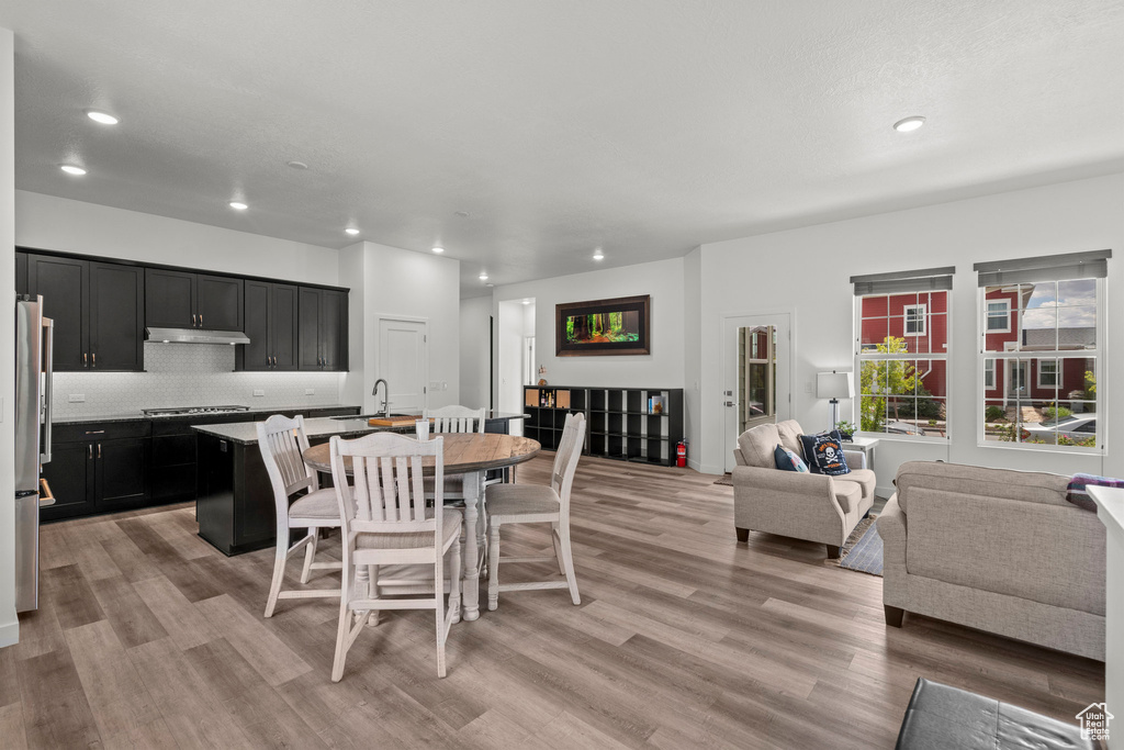 Dining space with light wood-style flooring and recessed lighting
