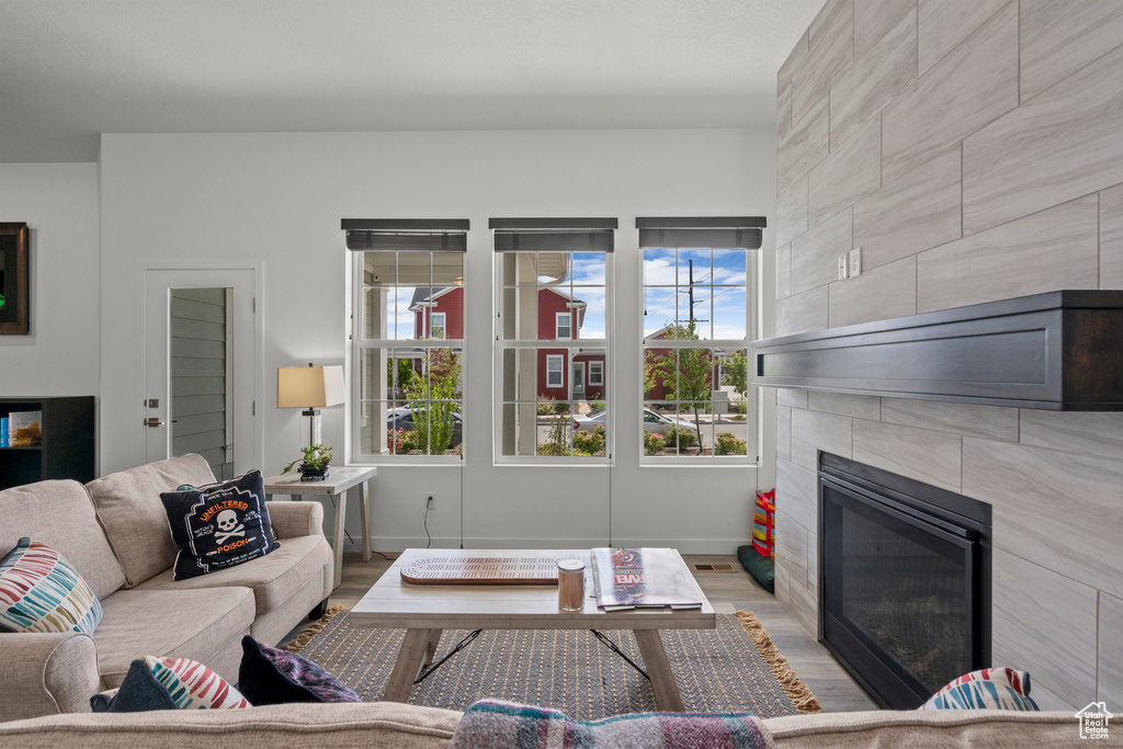 Living area with a fireplace and wood finished floors