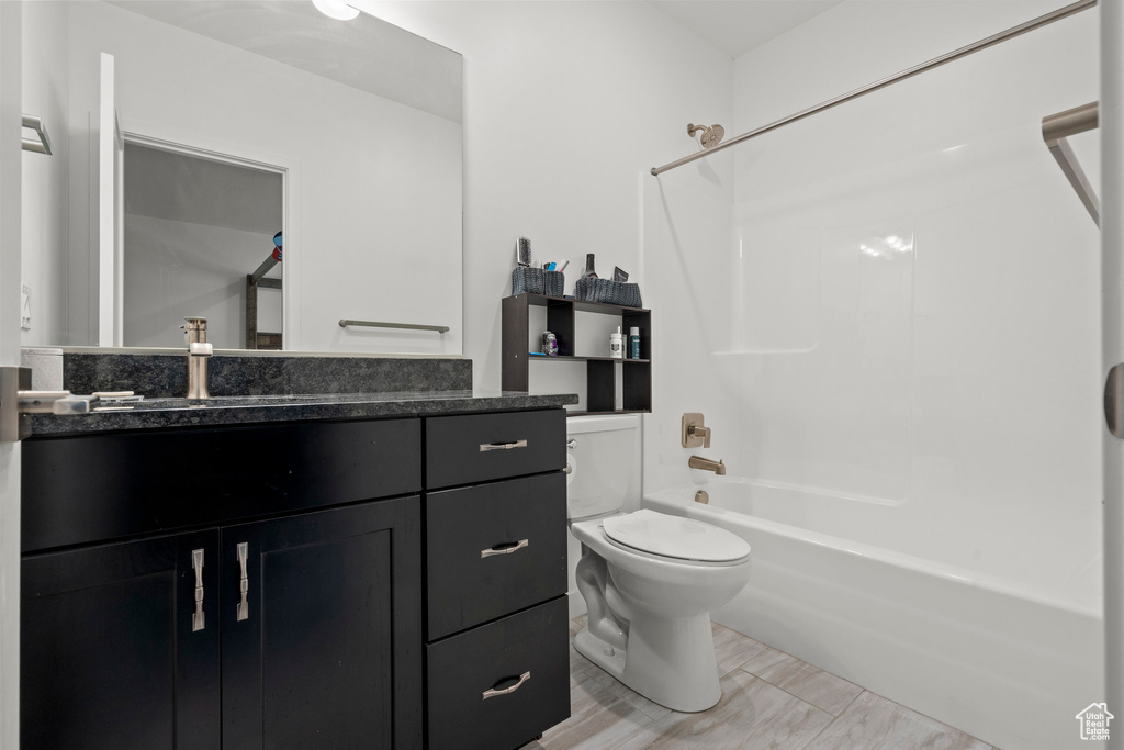Bathroom with vanity, toilet, and tub / shower combination