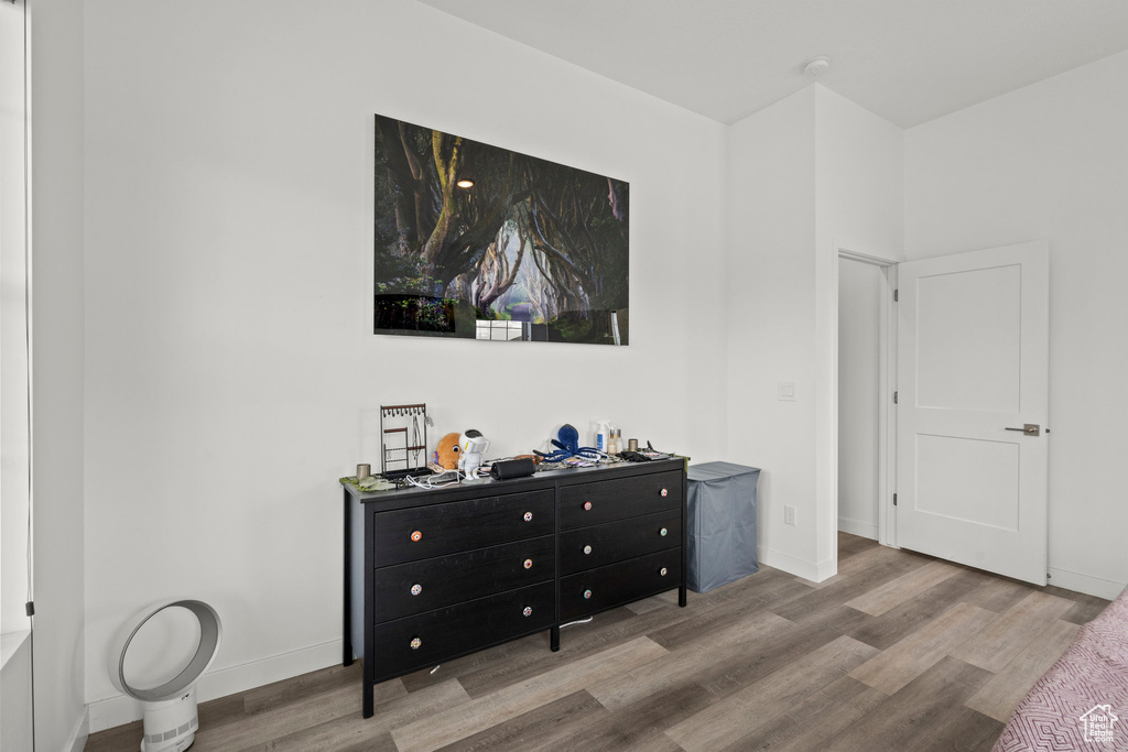 Bedroom featuring wood finished floors and baseboards
