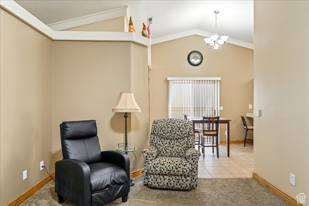 Sitting room with vaulted ceiling, a chandelier, baseboards, carpet floors, and tile patterned floors