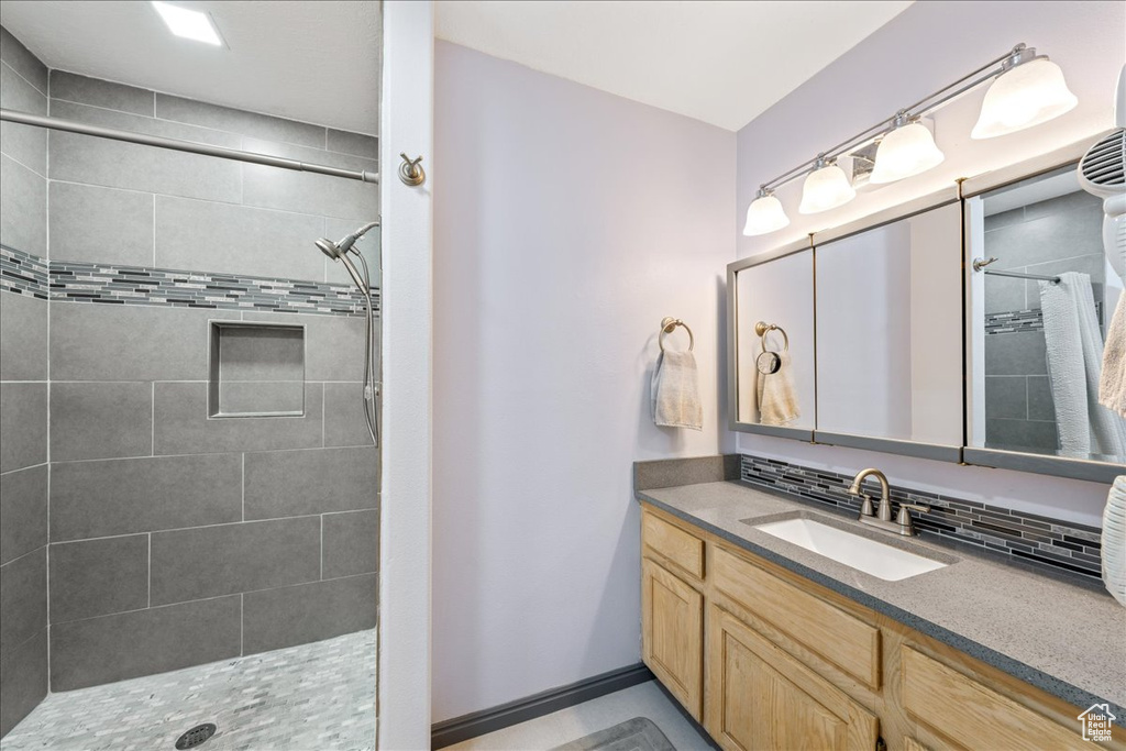 Full bathroom with tiled shower and vanity