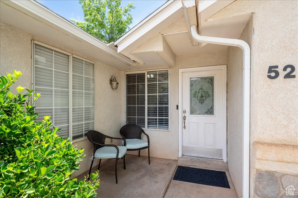 Property entrance featuring stucco siding