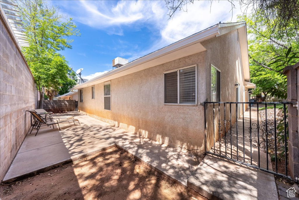 View of side of home with a patio and stucco siding