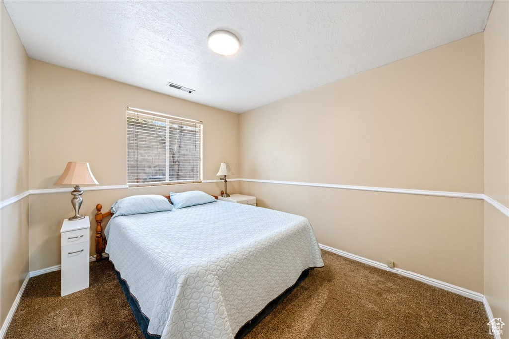 Carpeted bedroom with baseboards
