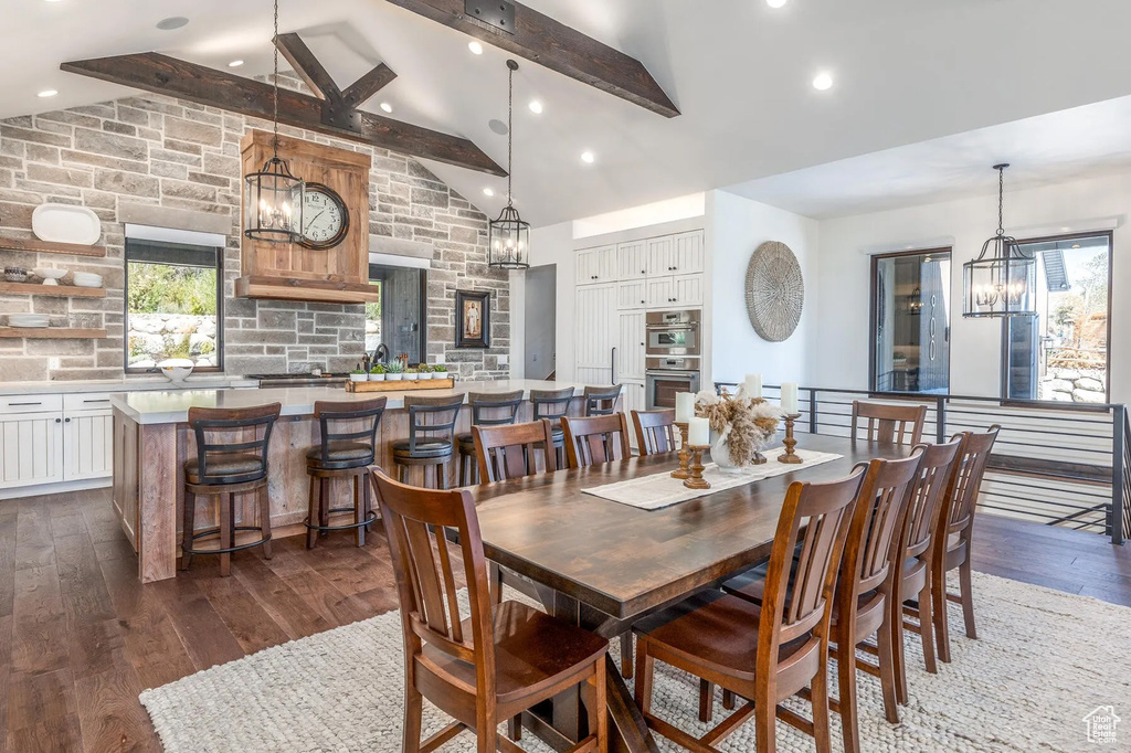 Dining area featuring a chandelier, dark wood-style flooring, beamed ceiling, recessed lighting, and high vaulted ceiling