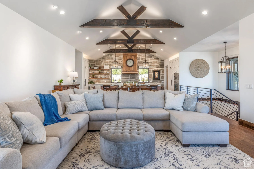 Living area with a chandelier, light wood-style floors, recessed lighting, and baseboards