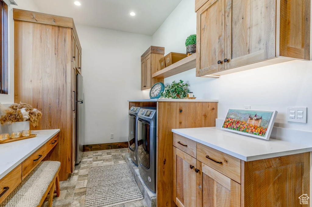 Laundry area with washer and clothes dryer, baseboards, cabinet space, and recessed lighting