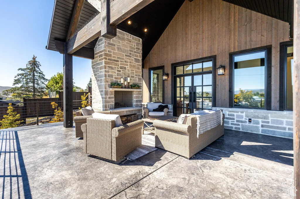 View of patio featuring an outdoor living space with a fireplace and french doors