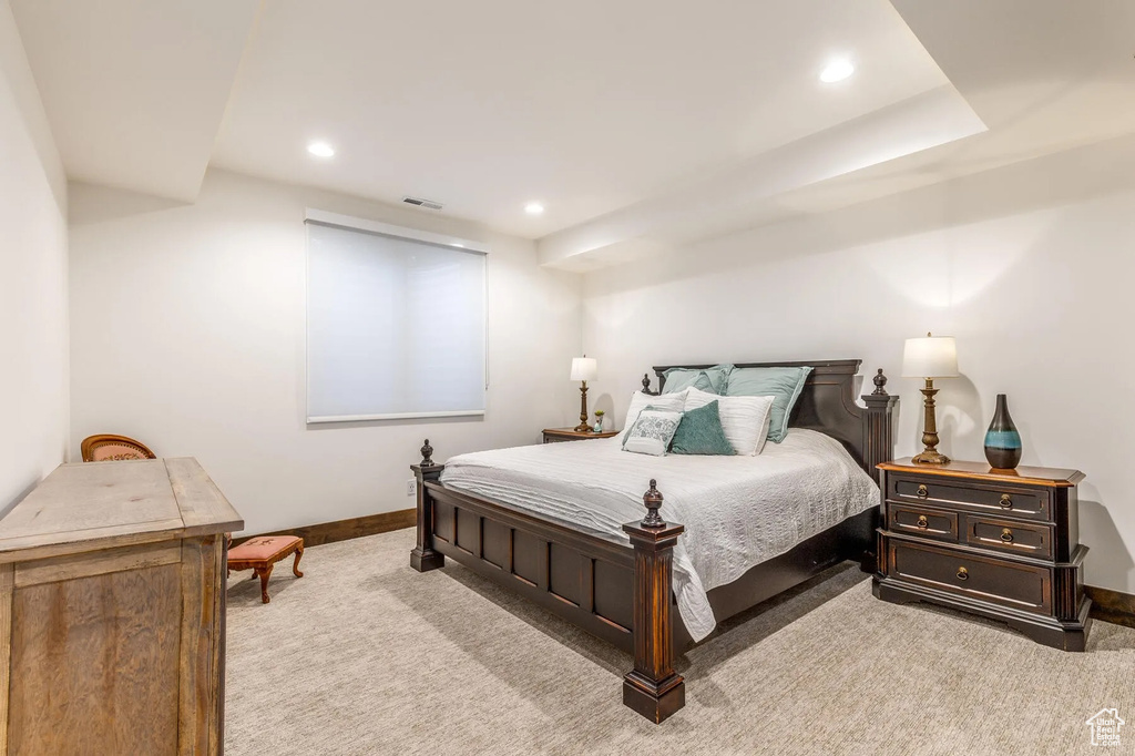 Bedroom with light colored carpet, baseboards, and recessed lighting