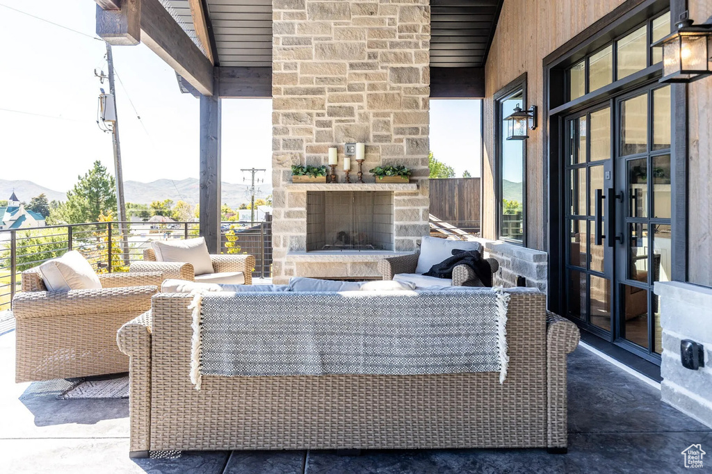 View of patio featuring a mountain view, french doors, and an outdoor living space with a fireplace