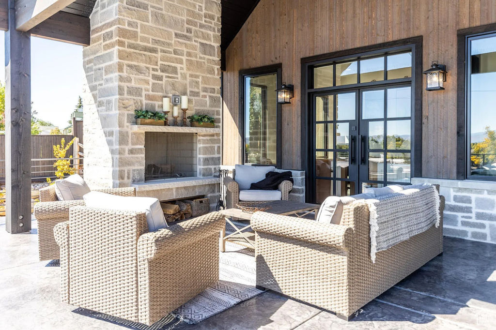 View of patio / terrace featuring french doors and an outdoor living space with a fireplace