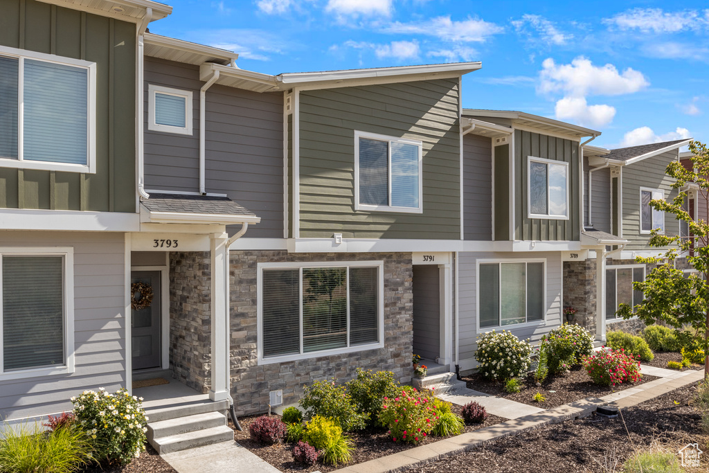 Multi unit property featuring board and batten siding and stone siding