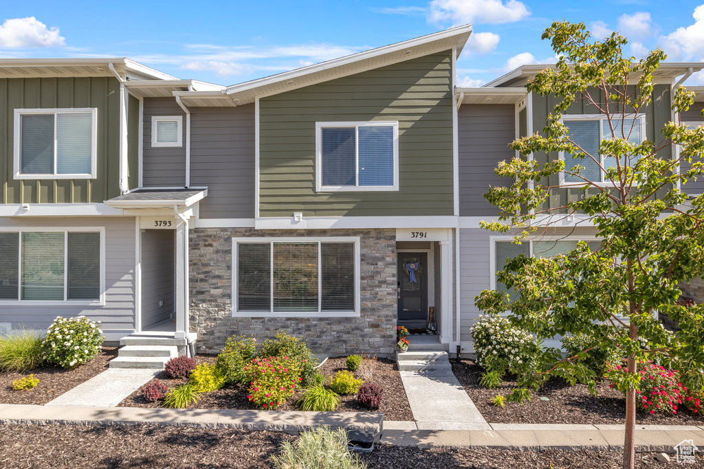Townhome / multi-family property featuring board and batten siding
