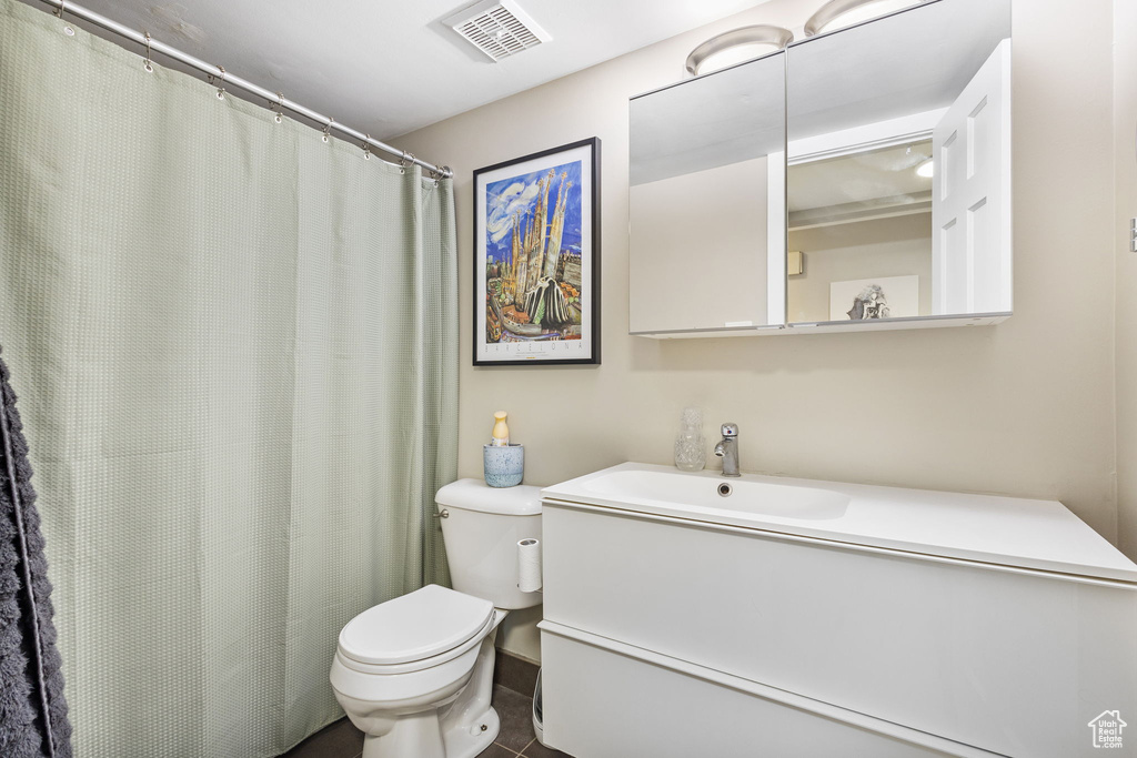 Full bath featuring toilet and vanity