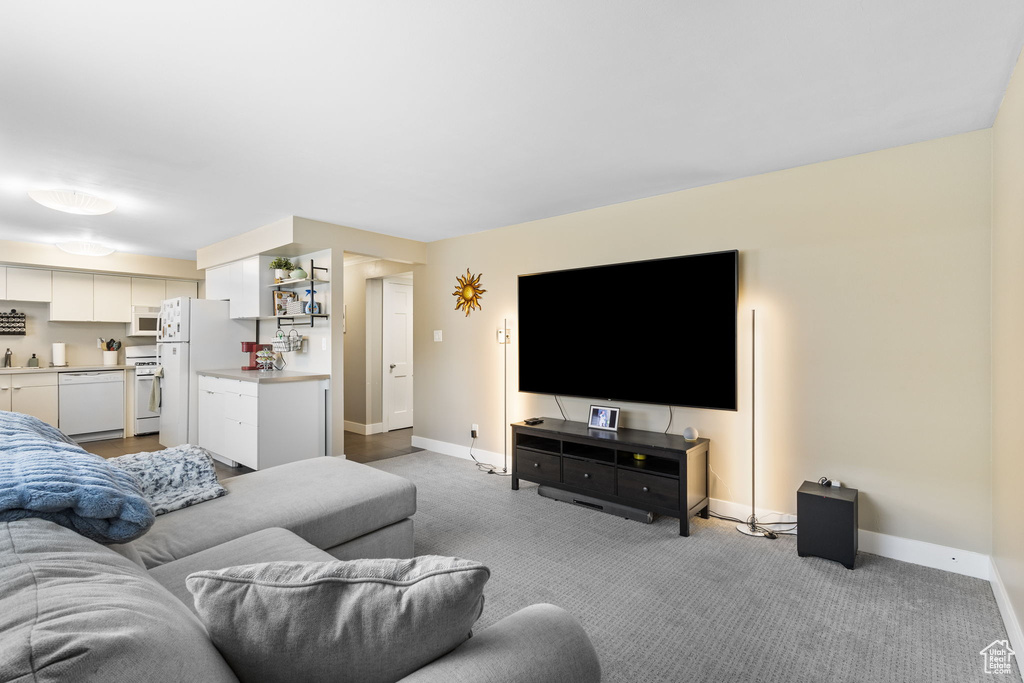 Living room with baseboards and light carpet