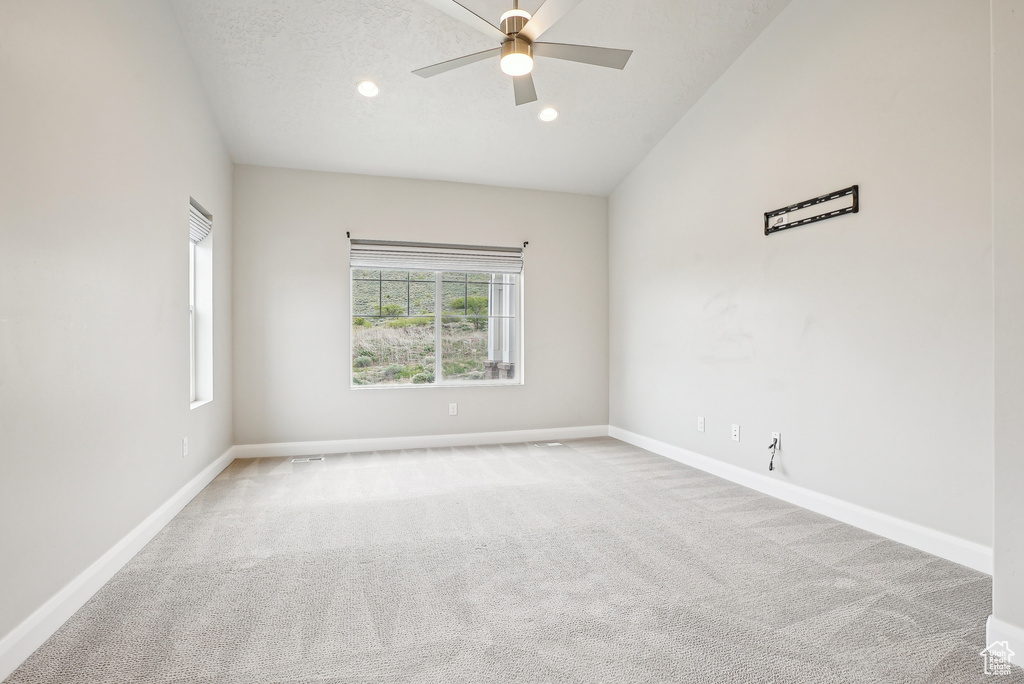 Spare room featuring carpet, a ceiling fan, baseboards, and recessed lighting