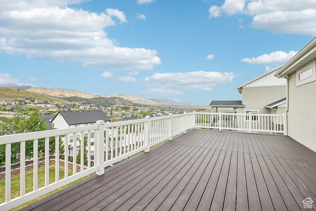 Wooden deck featuring a residential view and a mountain view