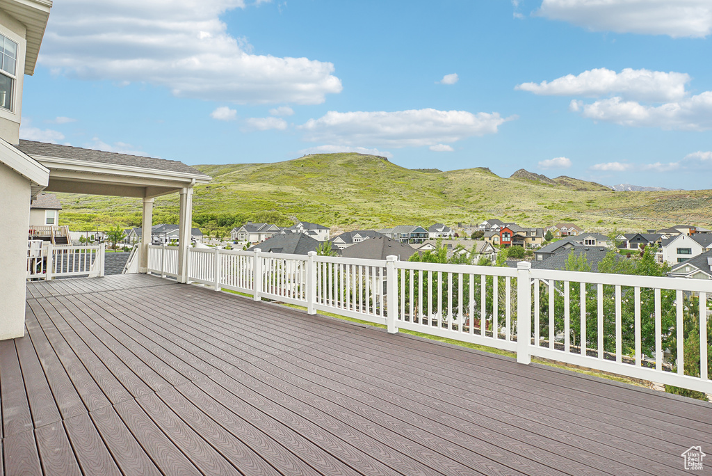 Wooden terrace with a residential view and a mountain view
