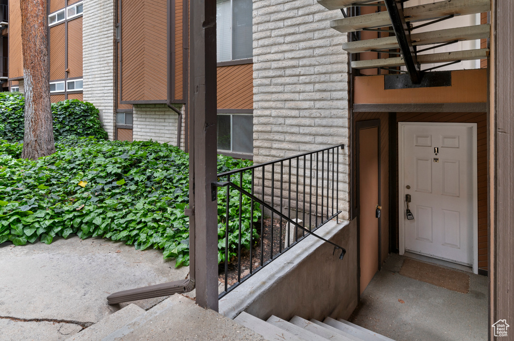 View of exterior entry featuring brick siding