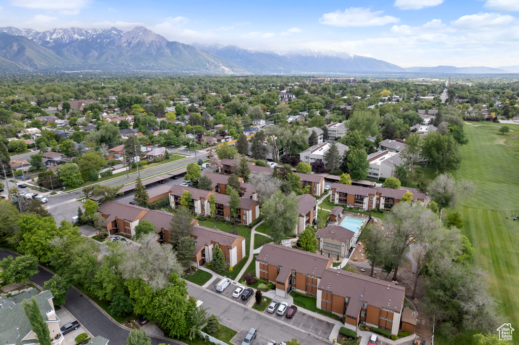 Aerial view of property and surrounding area with a mountainous background and nearby suburban area