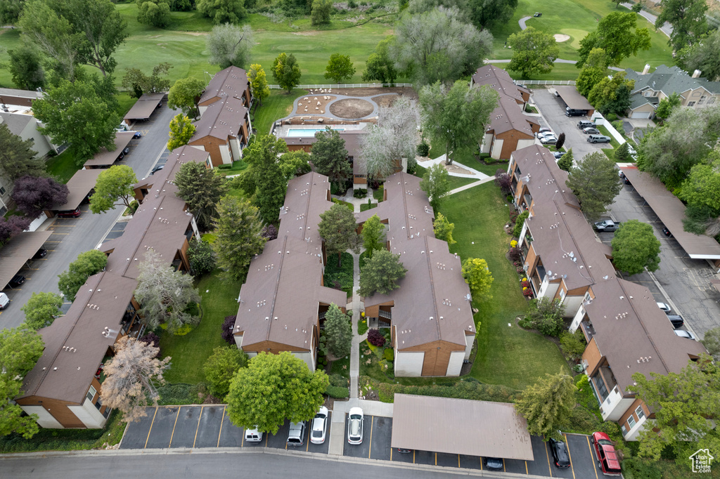 Aerial overview of property's location featuring nearby suburban area and a golf course