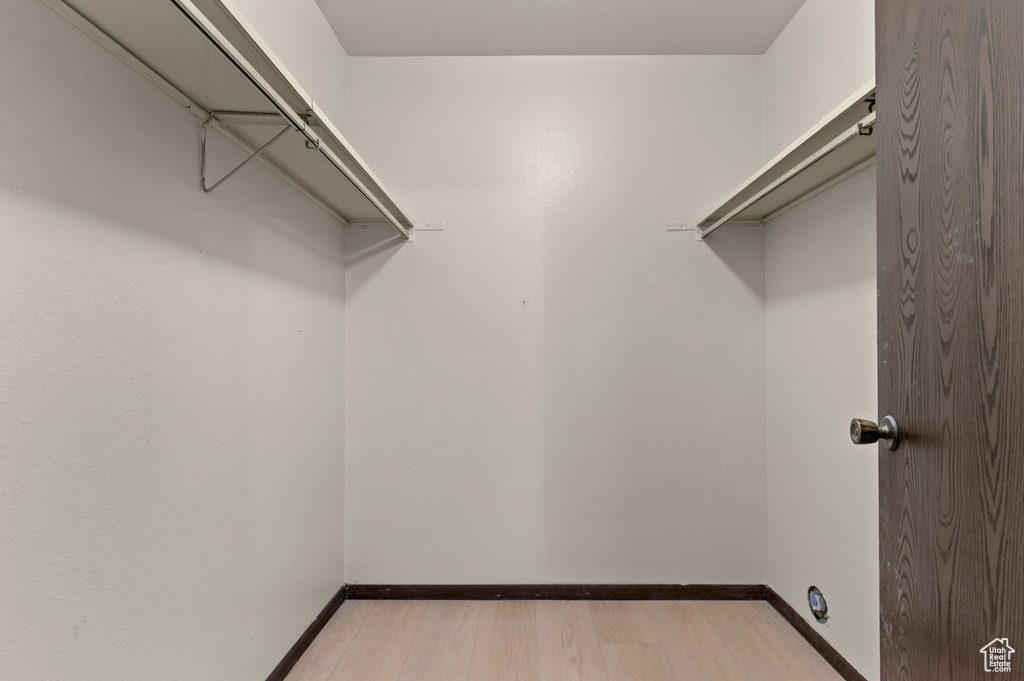 Spacious closet with light wood-style flooring