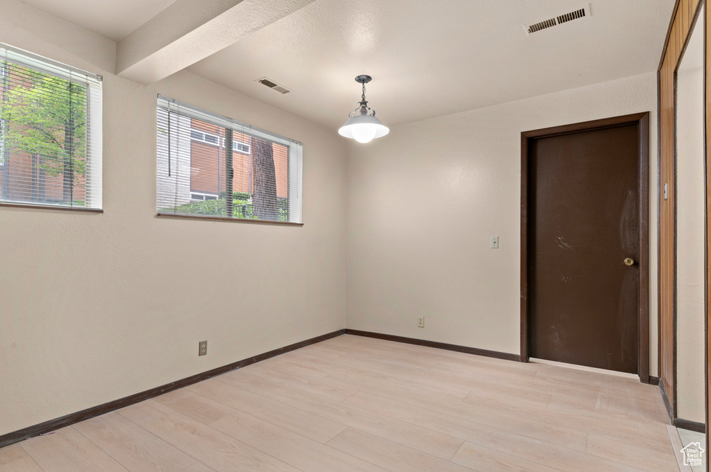 Spare room with light wood-style flooring and baseboards