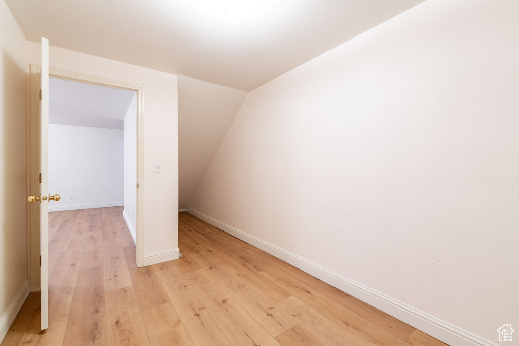 Additional living space featuring light wood-style floors and baseboards