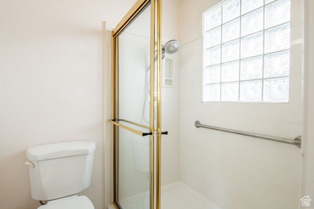 Full bath with a stall shower and toilet