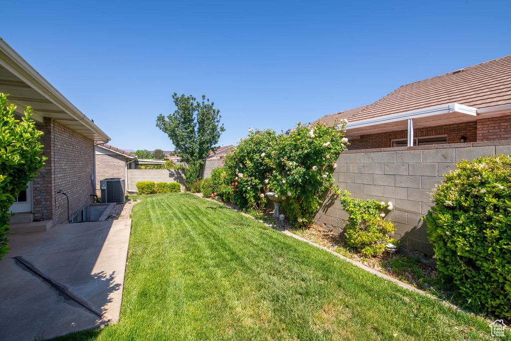 View of yard with cooling unit and a patio area