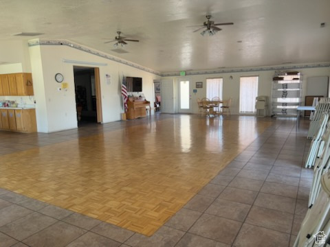 Unfurnished living room featuring ceiling fan