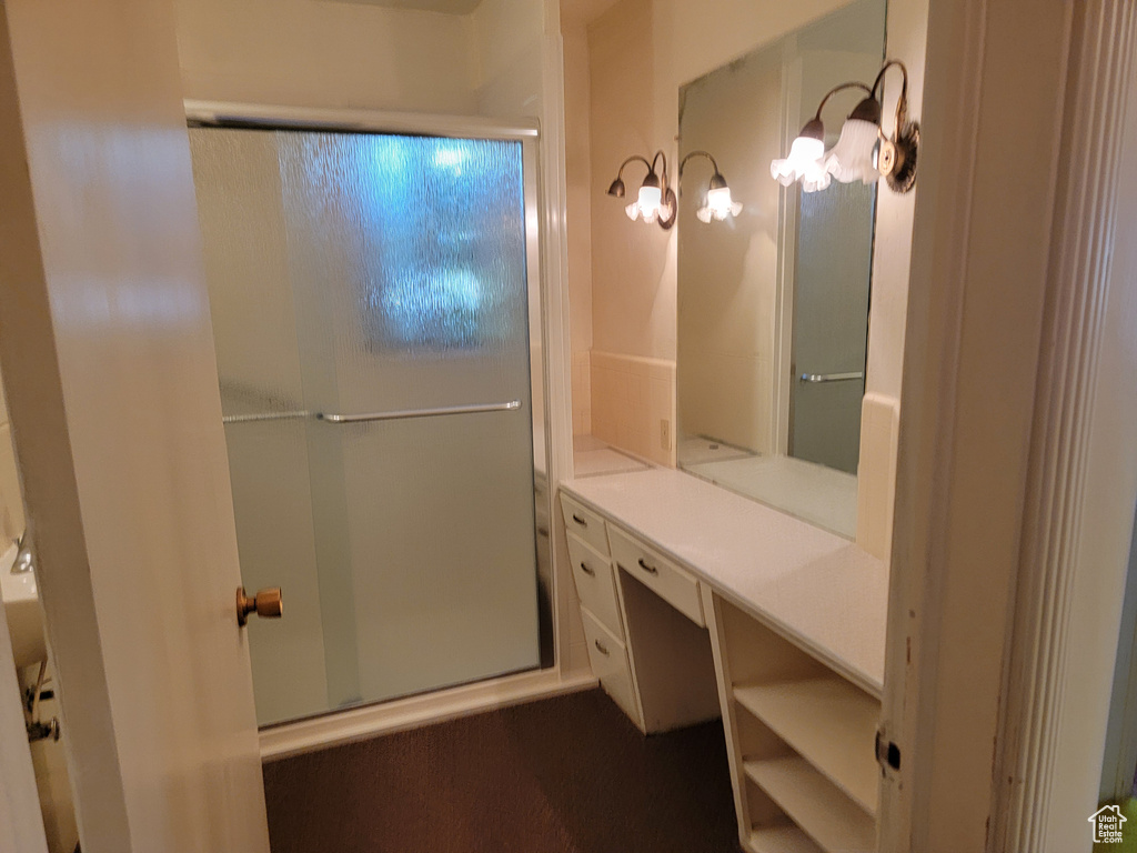 Full bathroom with a shower with door and vanity