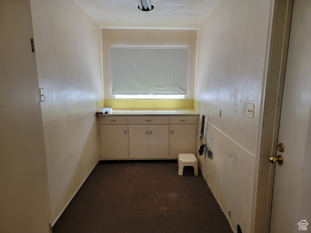 Hall featuring dark carpet