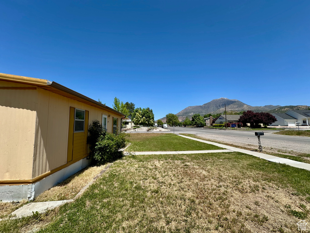 View of grassy yard featuring a mountain view