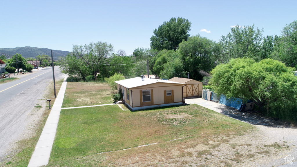 Rear view of property featuring driveway
