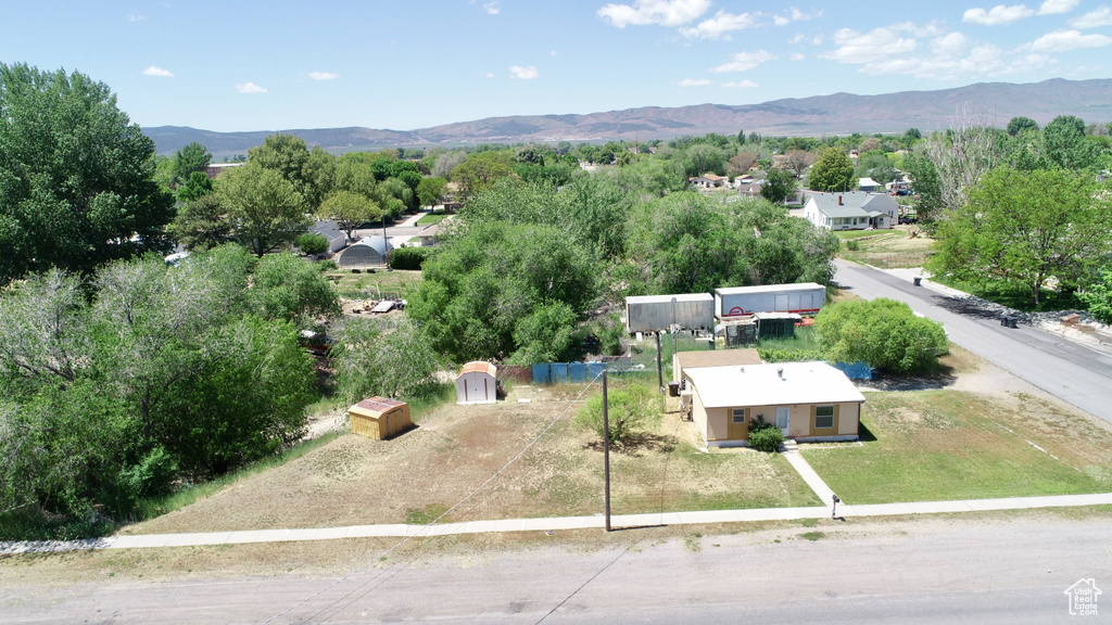 Aerial view of property and surrounding area with a mountainous background