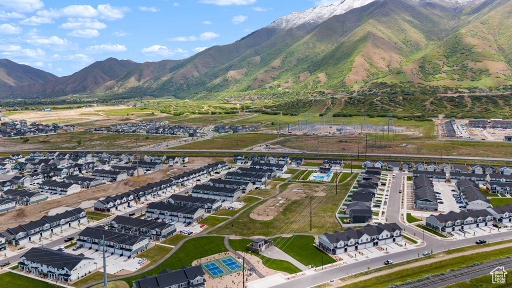 Aerial view of property's location featuring a mountain backdrop and nearby suburban area