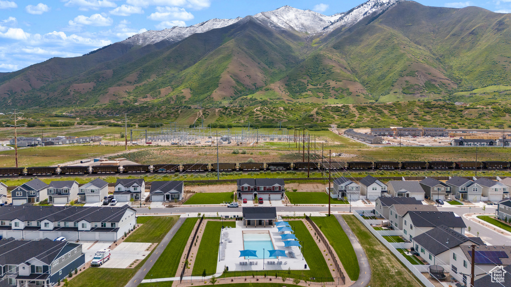 Aerial perspective of suburban area featuring mountains and a pool