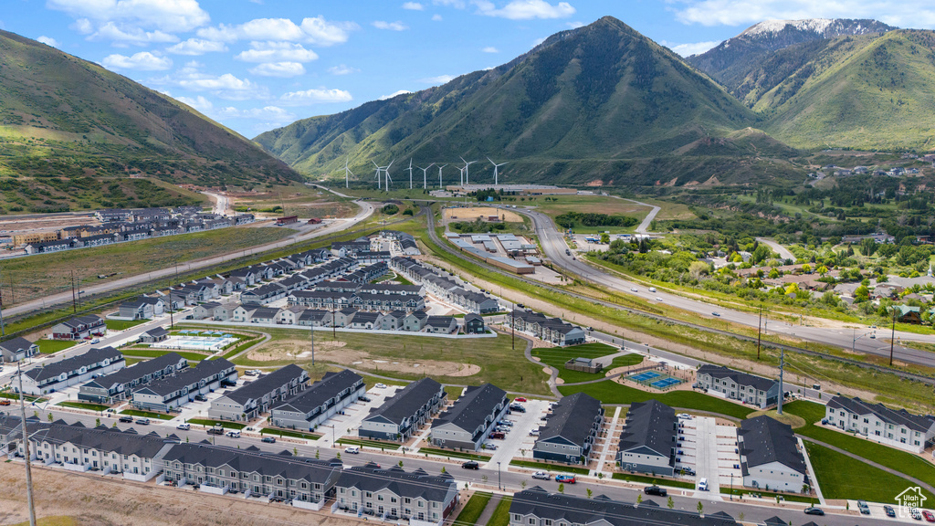 Aerial view of property and surrounding area featuring a mountain backdrop