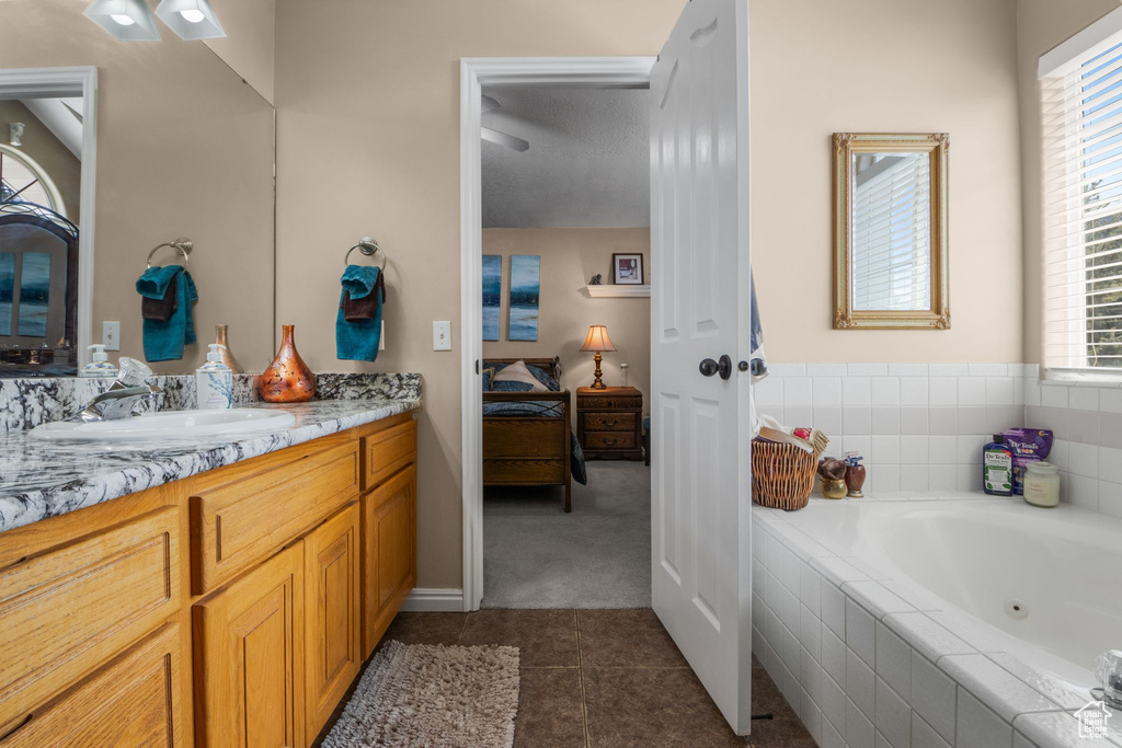 Full bathroom with tile patterned floors, a whirlpool tub, and vanity