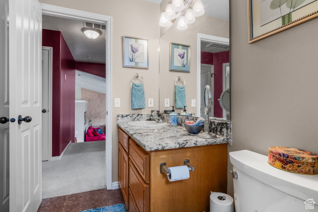 Bathroom with vanity, tile patterned flooring, and toilet