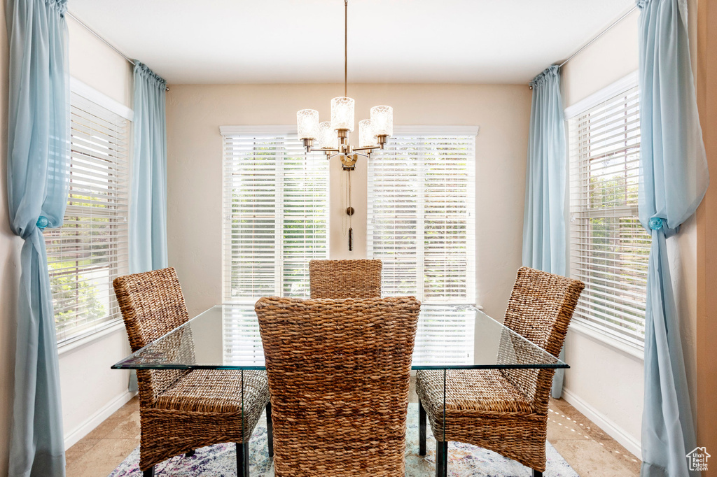 Dining space featuring a chandelier, healthy amount of natural light, and baseboards