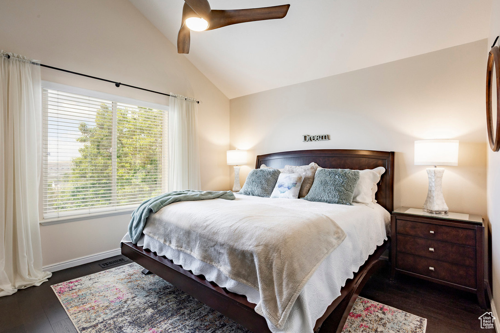 Bedroom featuring wood finished floors, a ceiling fan, baseboards, and high vaulted ceiling