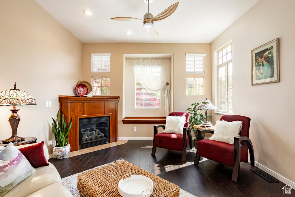 Living area with ceiling fan, hardwood / wood-style flooring, a fireplace with flush hearth, baseboards, and recessed lighting