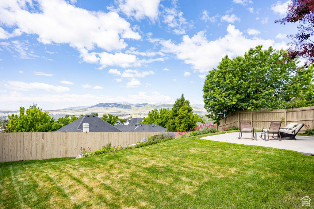 View of yard with a patio and a mountain view