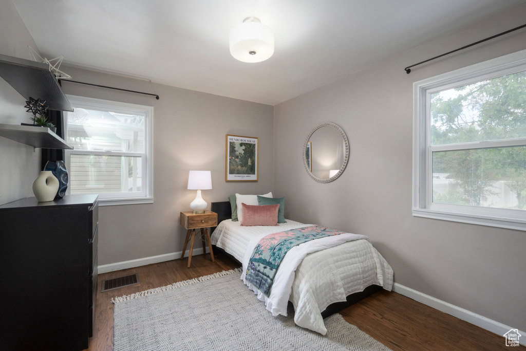 Bedroom featuring baseboards and wood finished floors