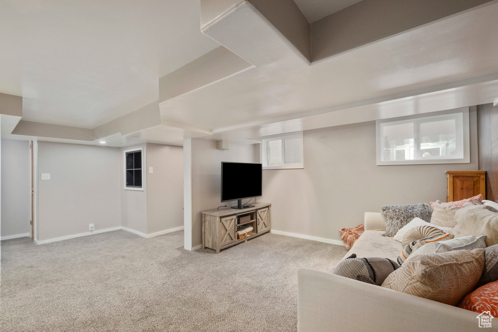 Carpeted living area featuring baseboards