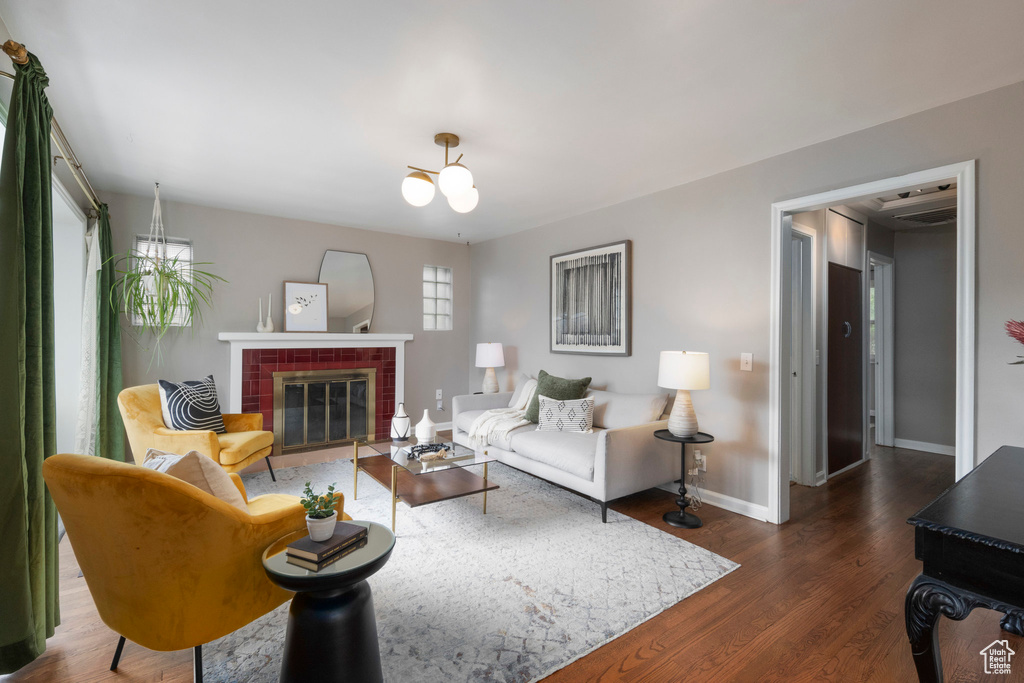 Living area with dark wood finished floors, baseboards, and a fireplace